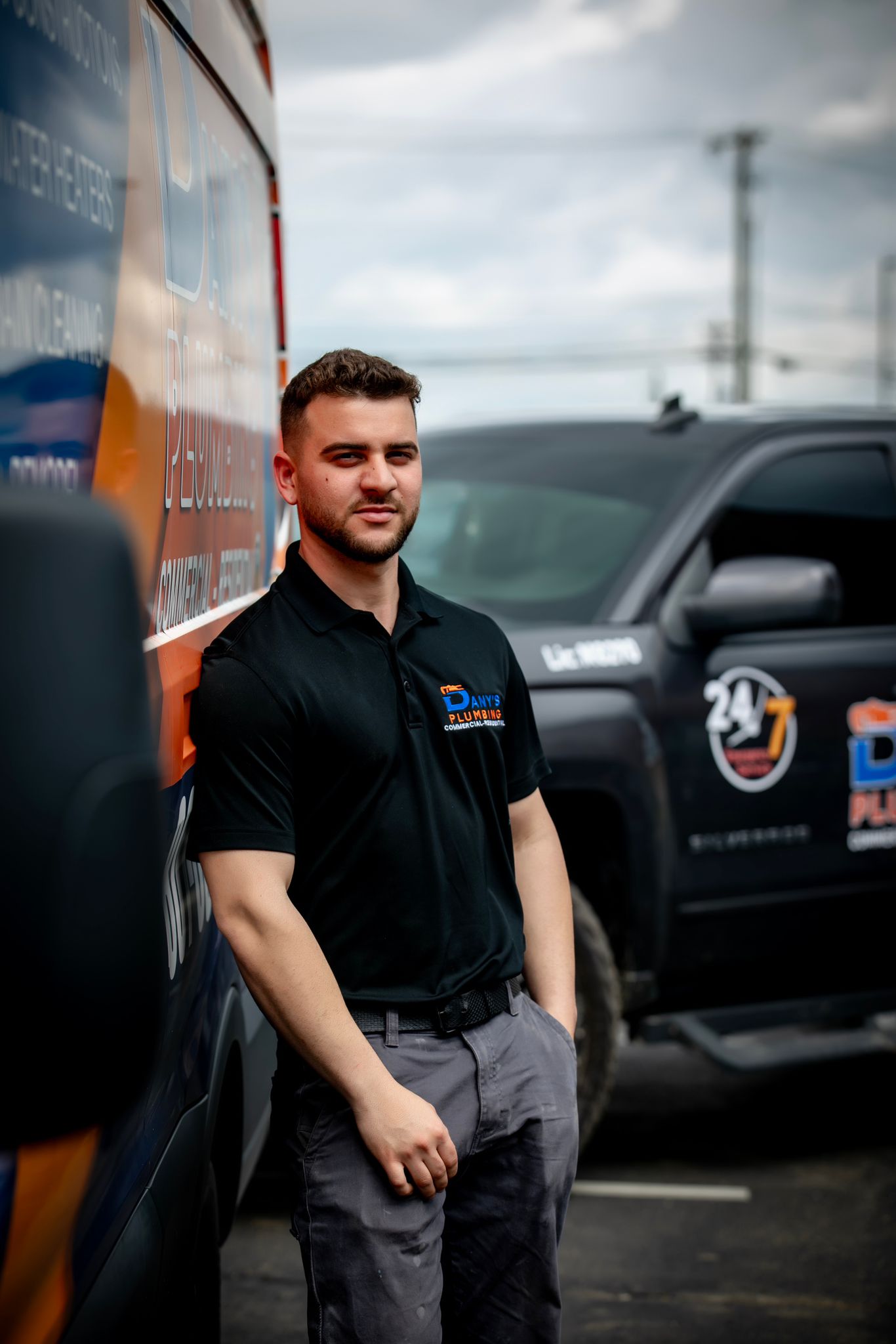 Dany in a Dany’s Plumbing shirt beside his lettered work truck